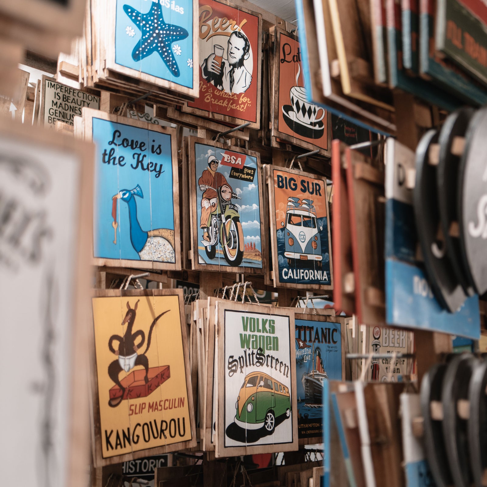 handpainted wooden signs on display in shop