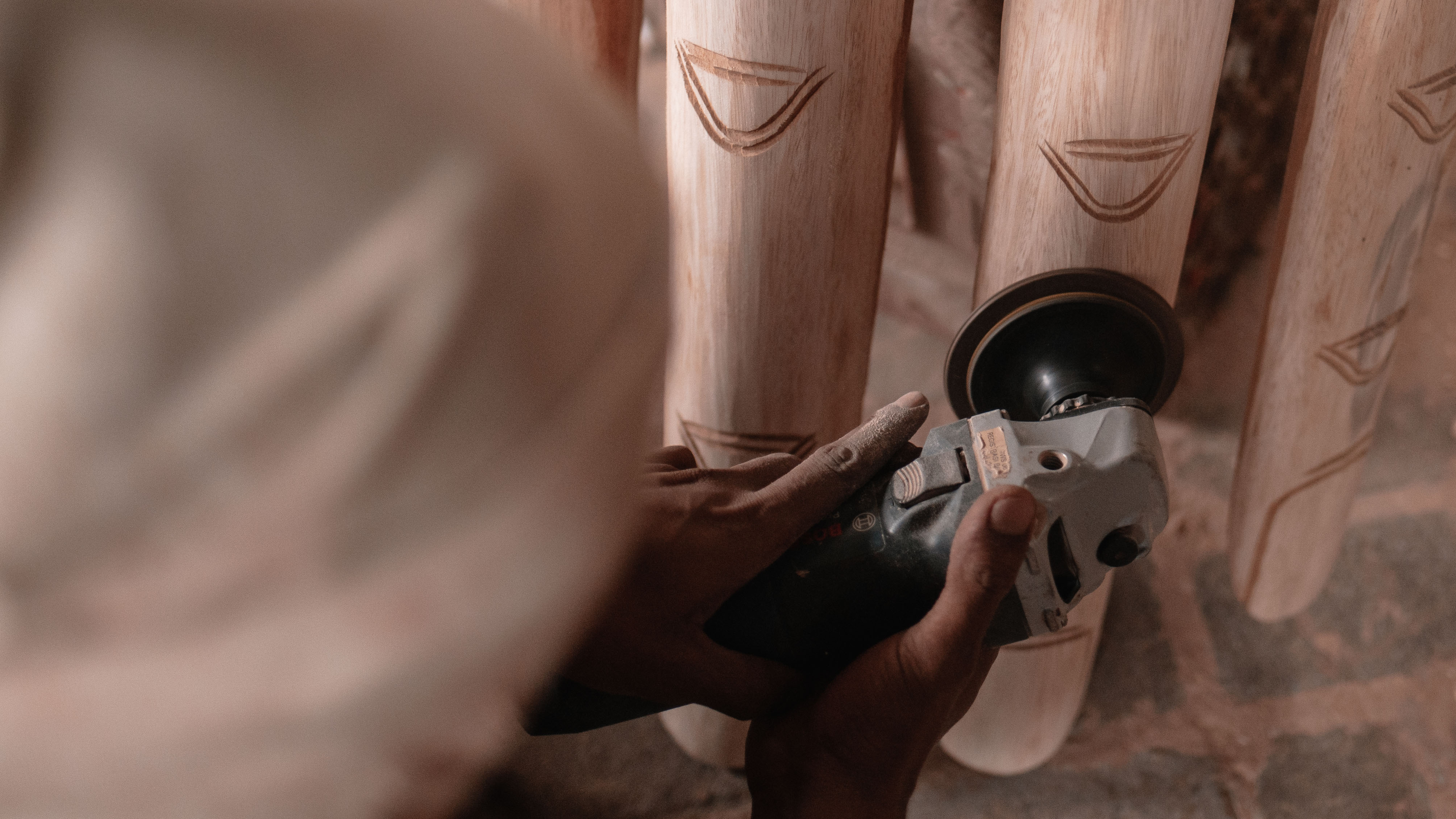 Worker-uses-sander-on-piece-of-furniture