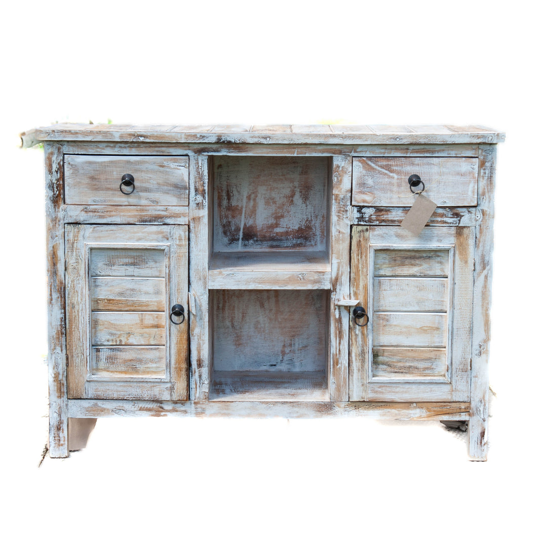 A medium size wooden cabinet in distressed white with 2 doors and storage shelves