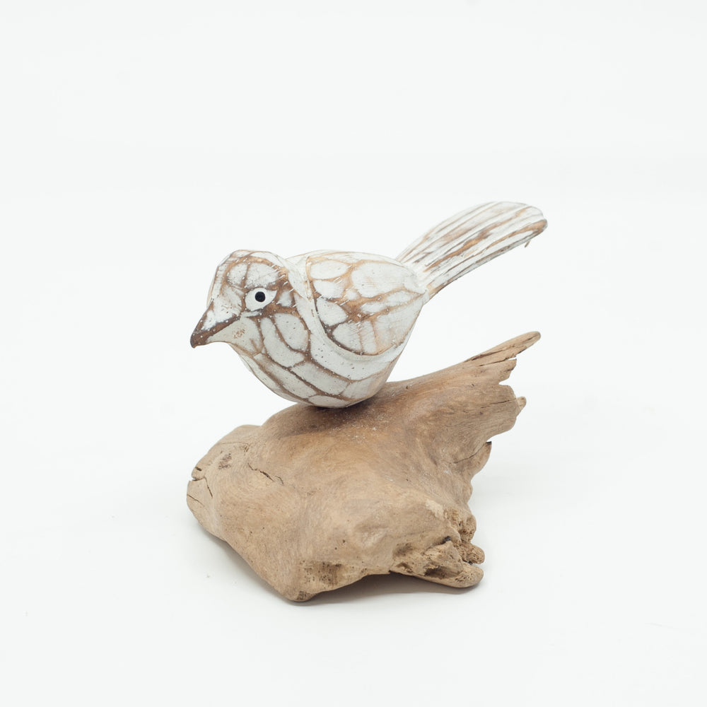 Small driftwood bird or on white background on wooden base. 