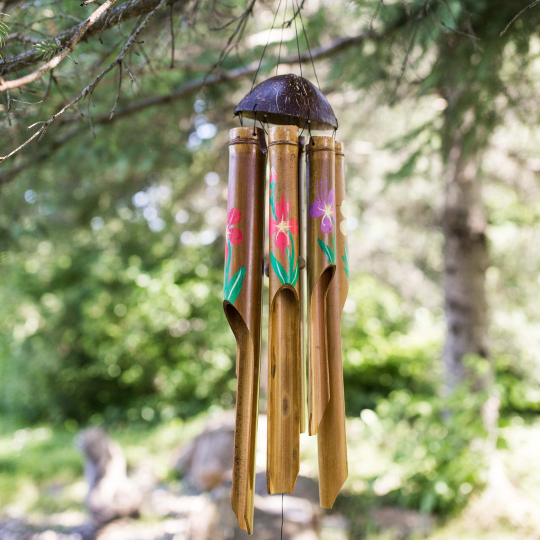 Photo of painted bamboo windchimes hanging in a tree