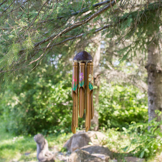 Photo of painted bamboo windchimes hanging in a tree