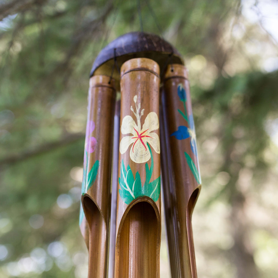 Photo of painted bamboo windchimes hanging in a tree