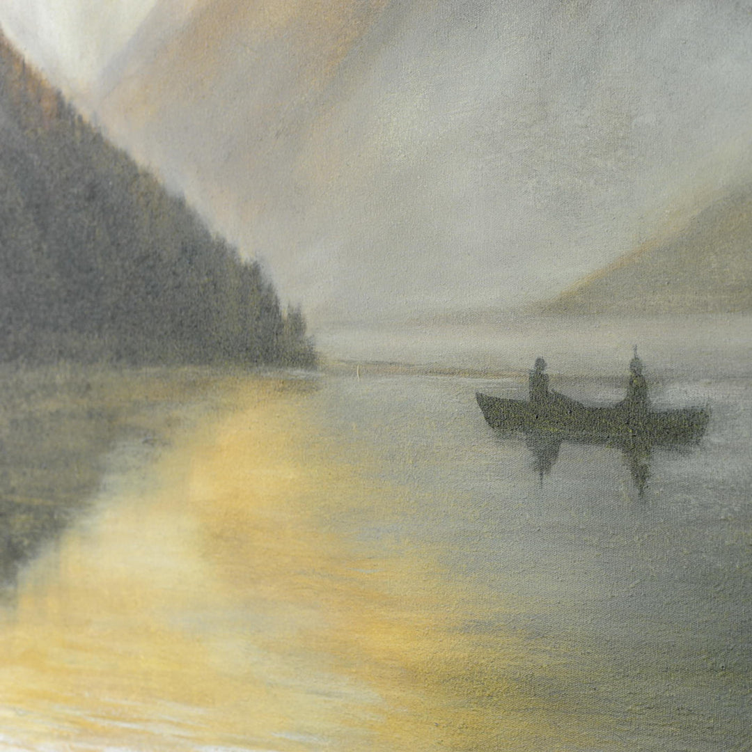 Canoeist on the water paddling on a mountainous lake