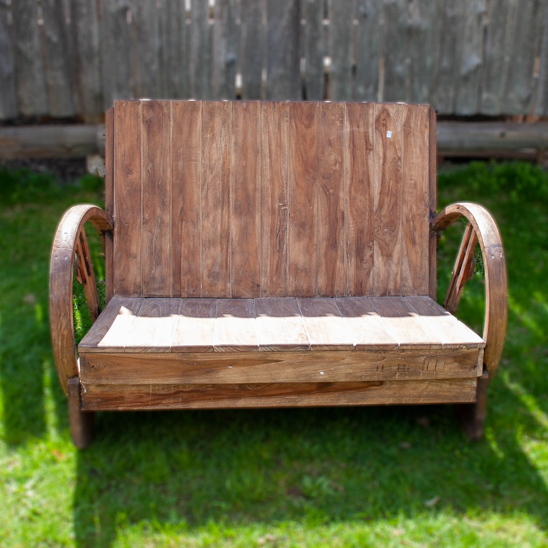 Simple wooden bench in natural wood with a laid back seat and low to the ground