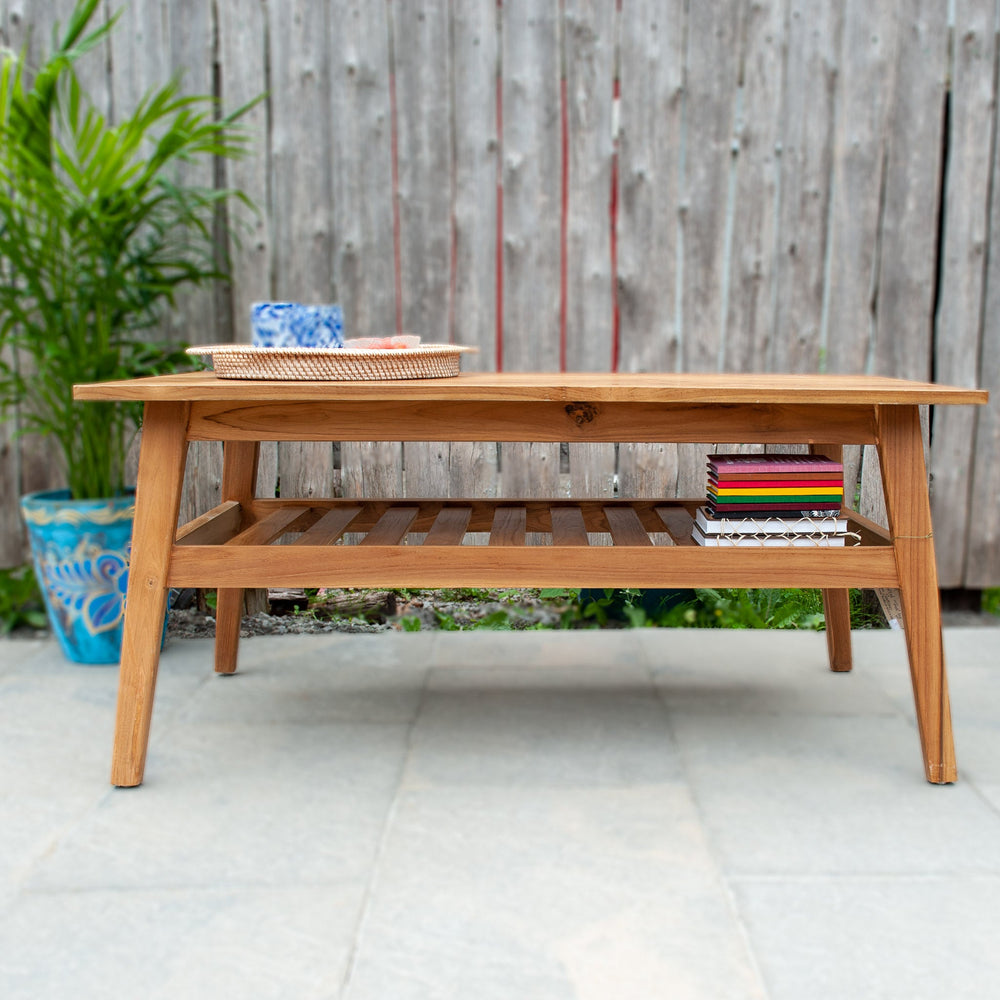 An image of a Javanese Teak Mid-Century Modern (MCM) style coffee table. The table features a sleek design with clean lines and a minimalist aesthetic. Made from rich teak wood, the coffee table showcases the natural beauty of the wood grain, creating a warm and inviting ambiance.