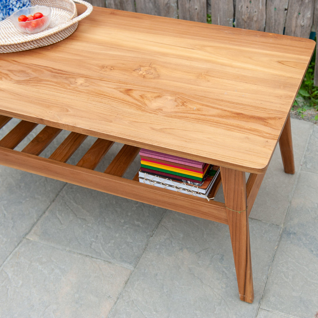 An image of a Javanese Teak Mid-Century Modern (MCM) style coffee table. The table features a sleek design with clean lines and a minimalist aesthetic. Made from rich teak wood, the coffee table showcases the natural beauty of the wood grain, creating a warm and inviting ambiance.