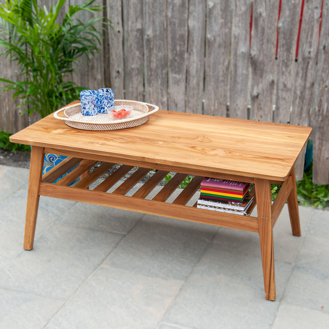 An image of a Javanese Teak Mid-Century Modern (MCM) style coffee table. The table features a sleek design with clean lines and a minimalist aesthetic. Made from rich teak wood, the coffee table showcases the natural beauty of the wood grain, creating a warm and inviting ambiance.