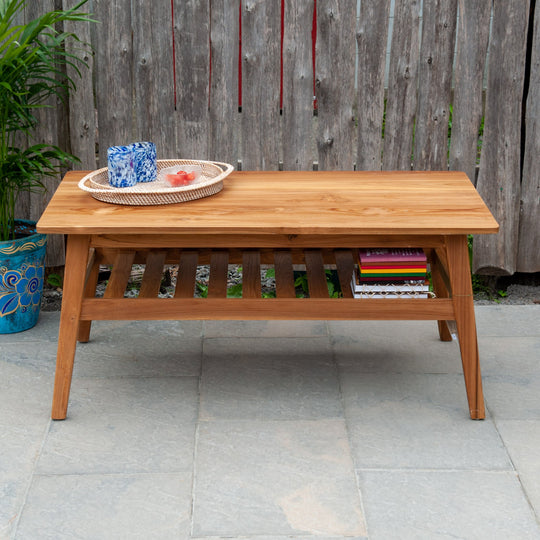 An image of a Javanese Teak Mid-Century Modern (MCM) style coffee table. The table features a sleek design with clean lines and a minimalist aesthetic. Made from rich teak wood, the coffee table showcases the natural beauty of the wood grain, creating a warm and inviting ambiance.