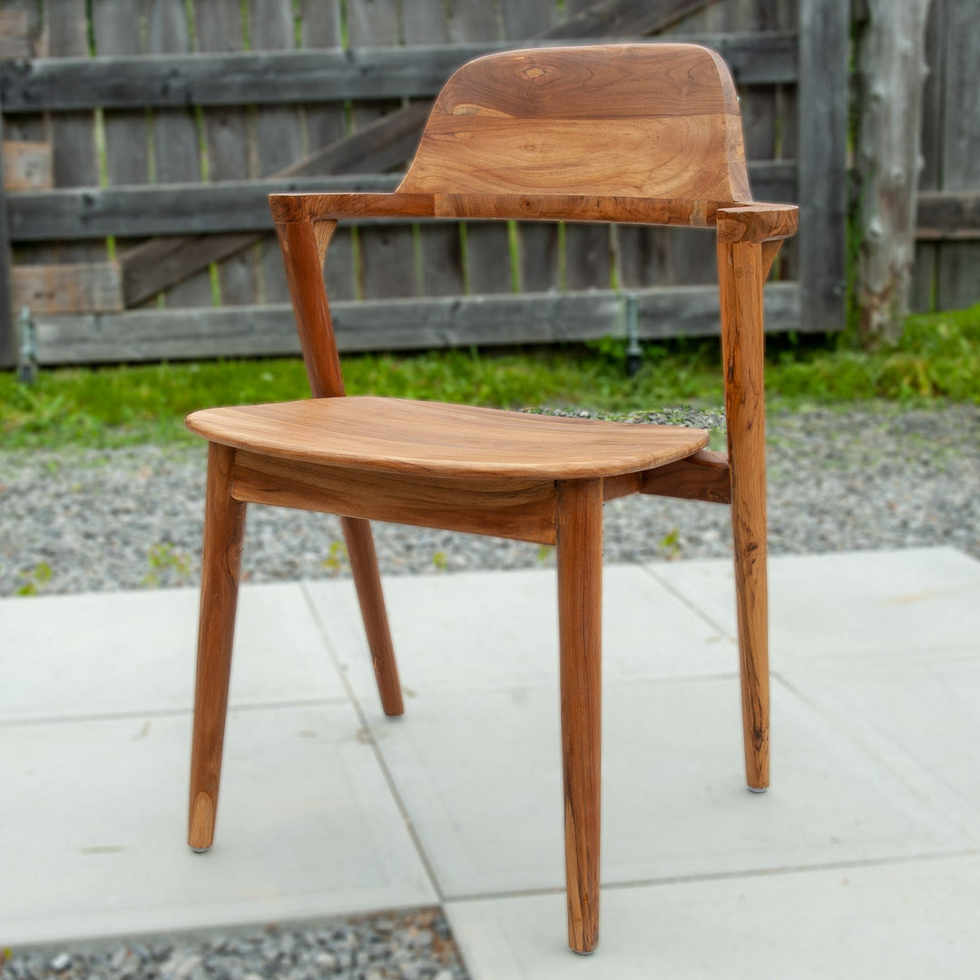 An image of a Javanese Teak Mid-Century Modern (MCM) style dining chair. The chair features a sleek design with clean lines and a minimalist aesthetic. Made from rich teak wood, the dining chair showcases the natural beauty of the wood grain, creating a warm and inviting ambiance.