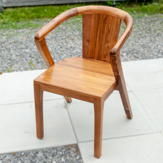 An image of a Javanese Teak Mid-Century Modern (MCM) style dining chair. The chair features a sleek design with clean lines and a minimalist aesthetic. Made from rich teak wood, the dining chair showcases the natural beauty of the wood grain, creating a warm and inviting ambiance.