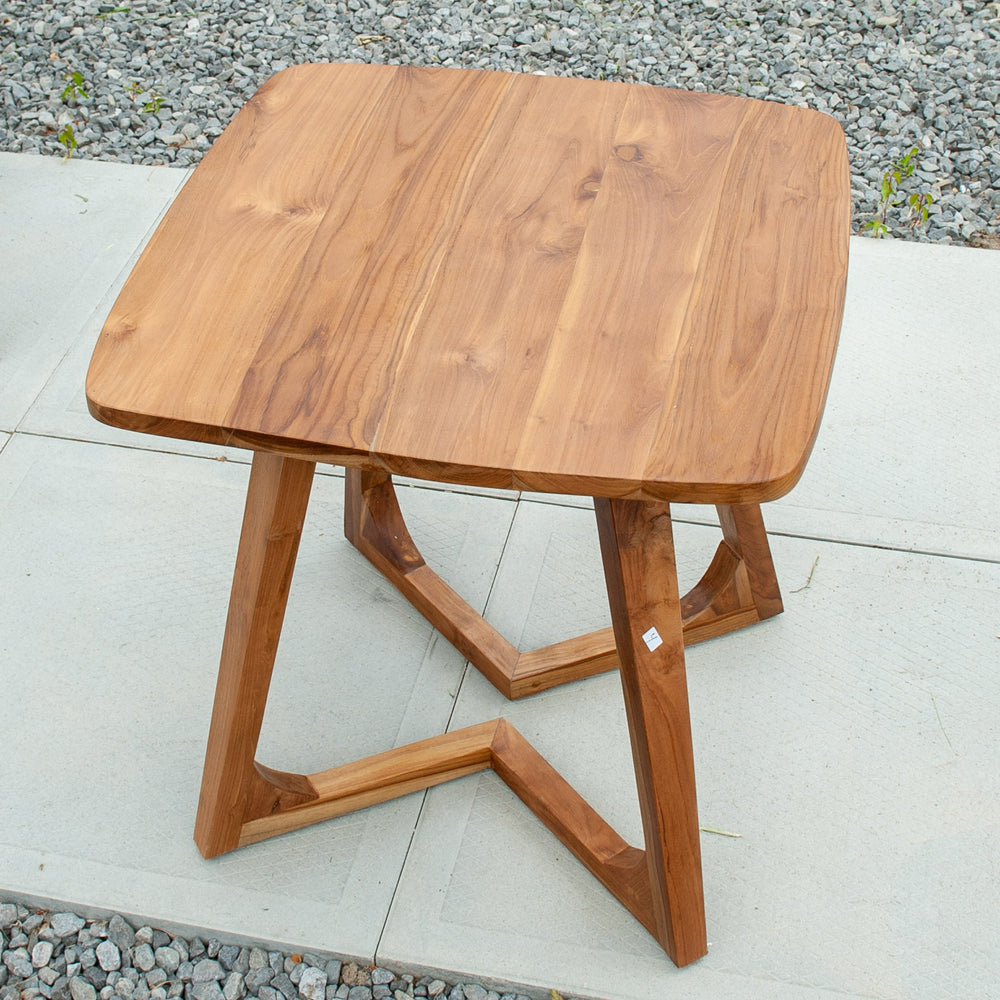 An image of a Javanese Teak Mid-Century Modern (MCM) style tall table. The table features a sleek design with clean lines and a minimalist aesthetic. Made from rich teak wood, the table showcases the natural beauty of the wood grain, creating a warm and inviting ambiance.