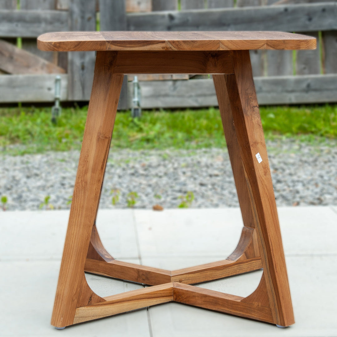 An image of a Javanese Teak Mid-Century Modern (MCM) style tall table. The table features a sleek design with clean lines and a minimalist aesthetic. Made from rich teak wood, the table showcases the natural beauty of the wood grain, creating a warm and inviting ambiance.