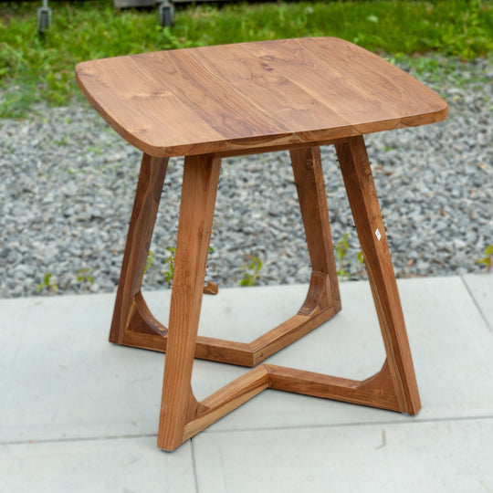 An image of a Javanese Teak Mid-Century Modern (MCM) style tall table. The table features a sleek design with clean lines and a minimalist aesthetic. Made from rich teak wood, the table showcases the natural beauty of the wood grain, creating a warm and inviting ambiance.