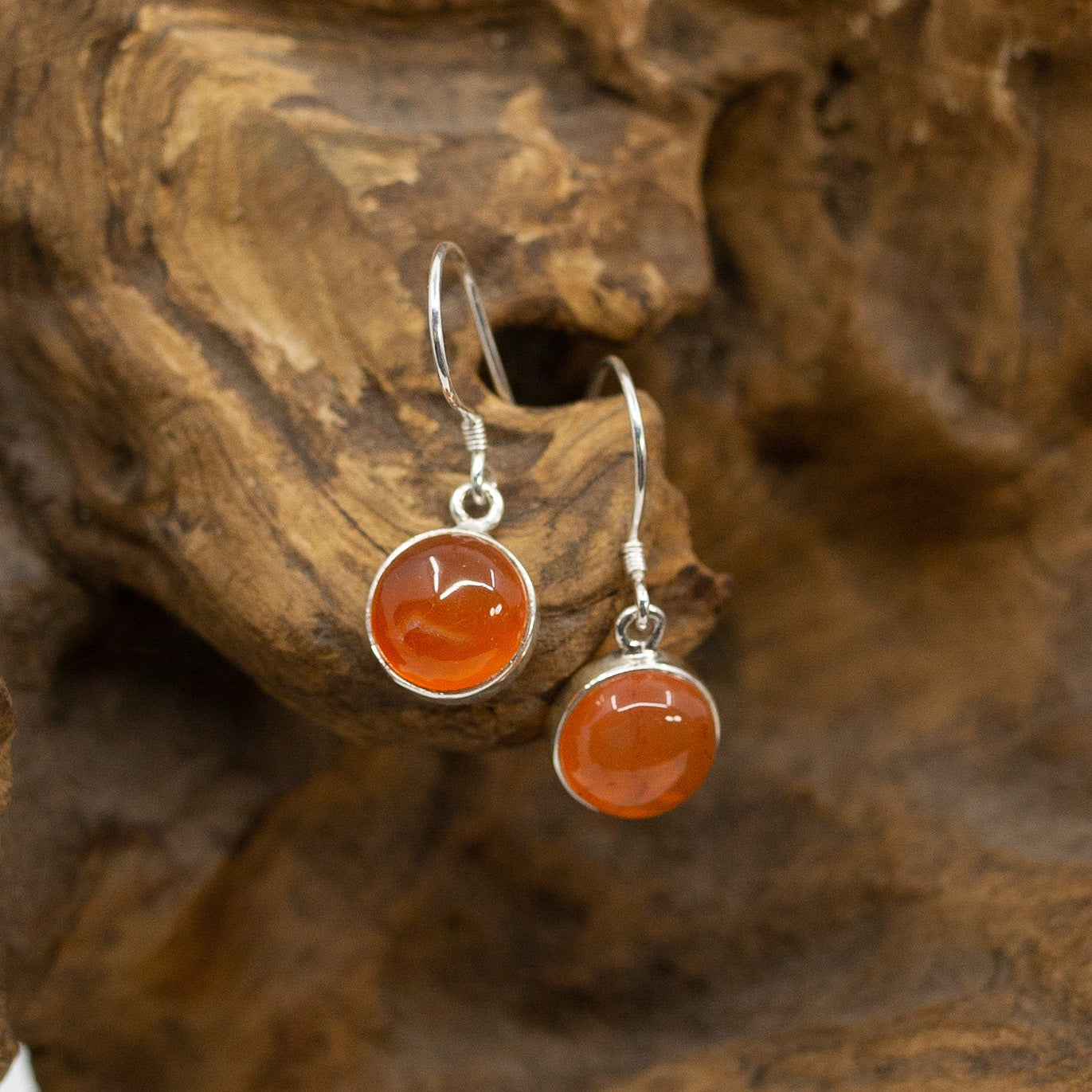 Bali Circle Carnelian Dangle Earrings on wood