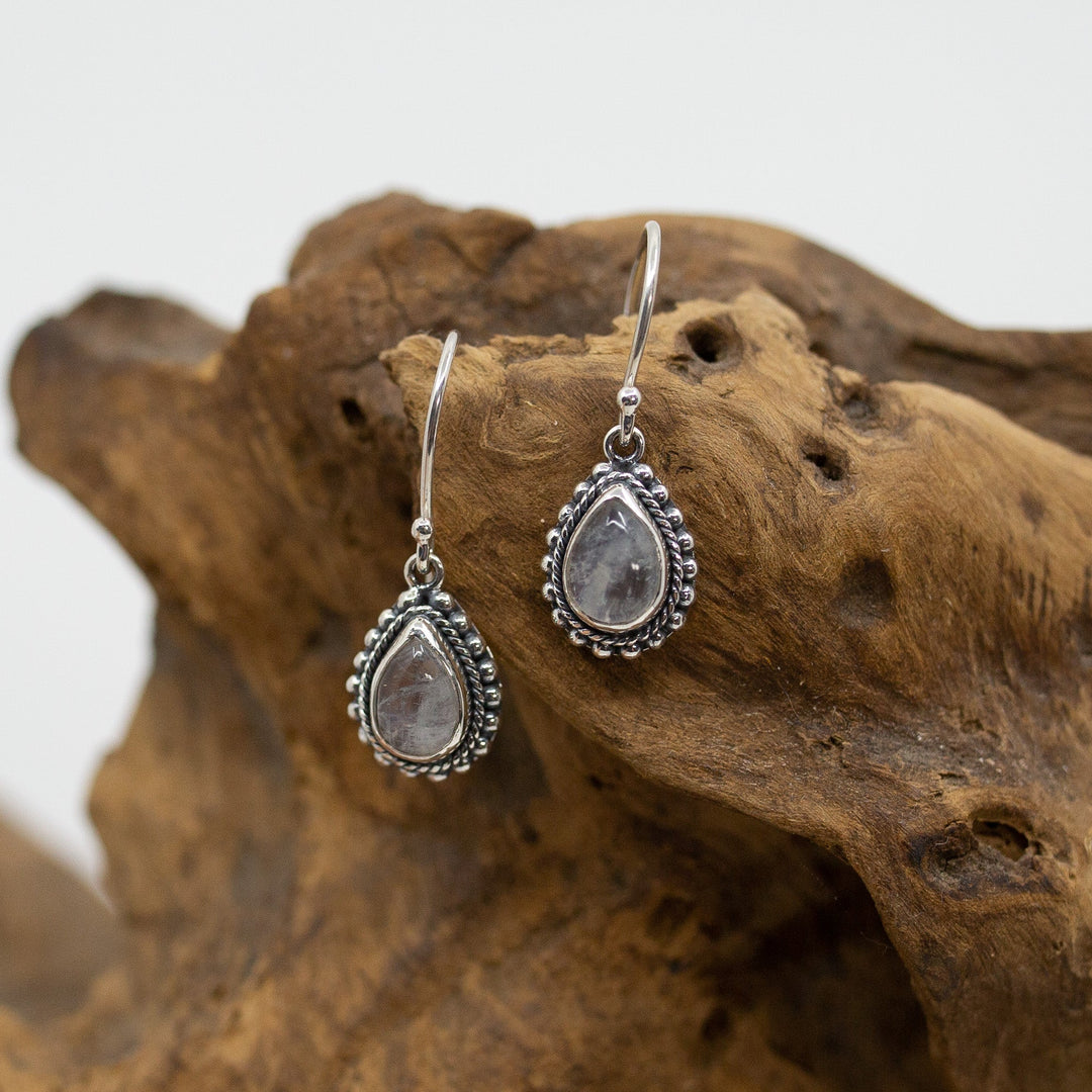 Bali Ornate Moonstone Teardrop Dangle Earrings on wood