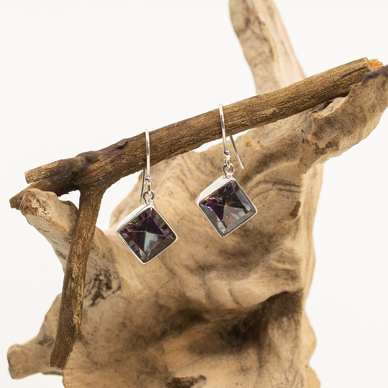 Bali Mystic Topaz Square Pendant Dangle Earrings on wood