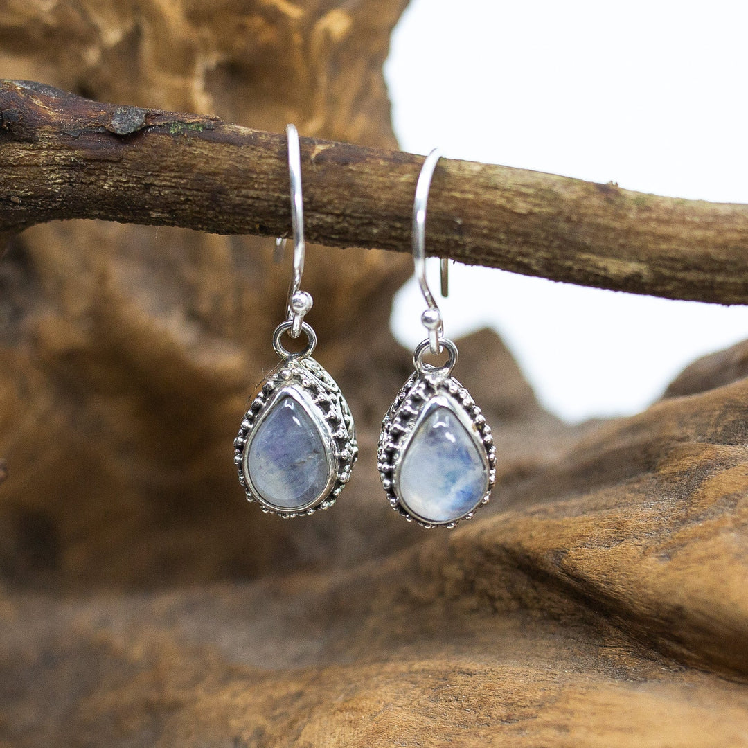 Bali Silvery Blue Moonstone Teardrop Dangle Earrings on wood