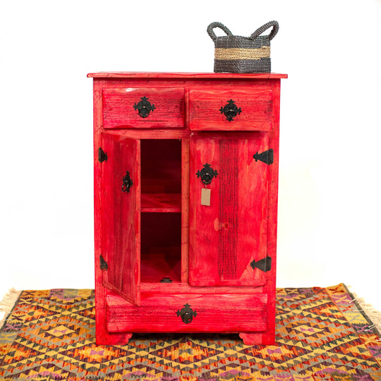 Photo of a tall Mexican cabinet with drawers and dressers in a vibrant red