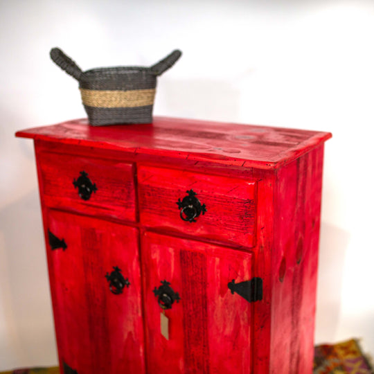 Photo of a tall Mexican cabinet with drawers and dressers in a vibrant red