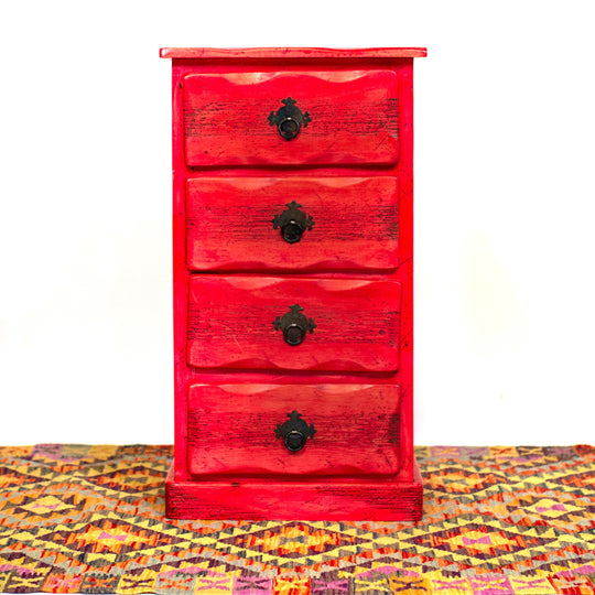 Photo of 4 drawer small mexican dresser in red.