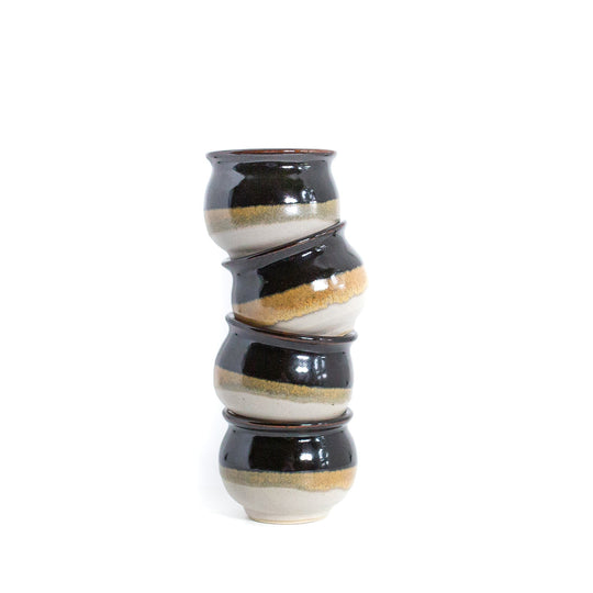 Small brown honey pot style jars stacked