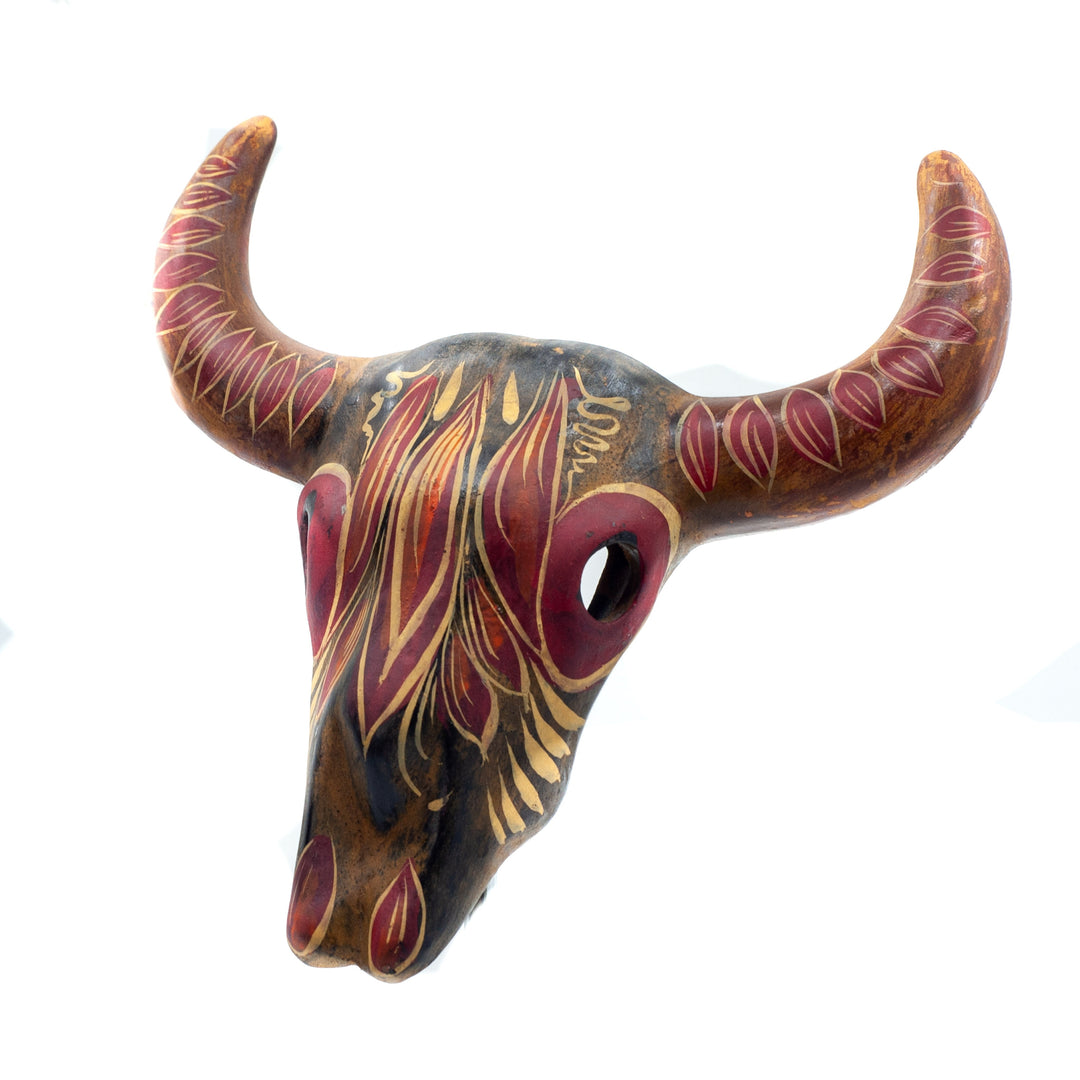 Photo of small terracotta cow skull with handpainted designs