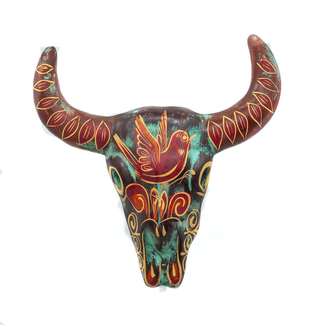 Photo of small terracotta cow skull with handpainted designs