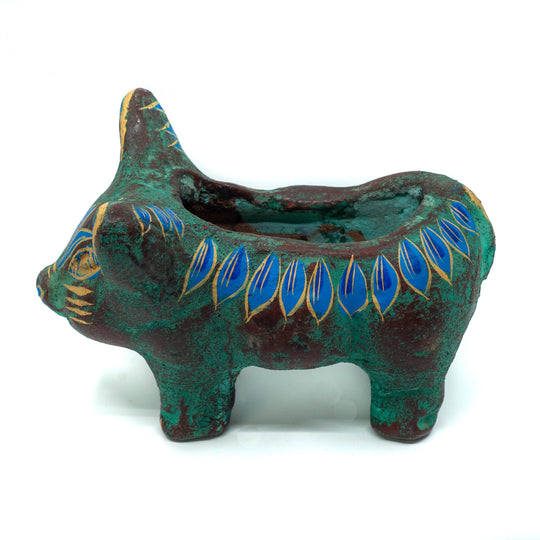 Photo of small terracotta cow skull with handpainted designs