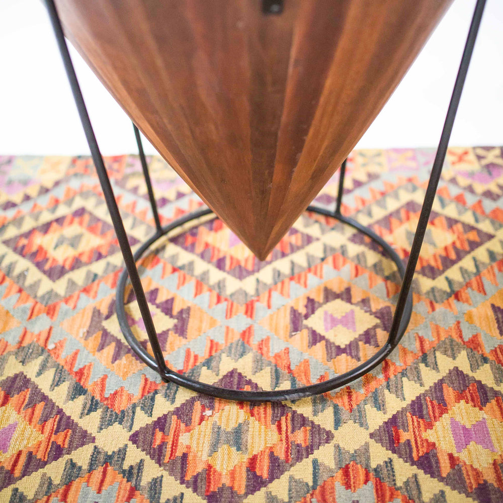 Photo of a upside down cone shaped table with metal legs 