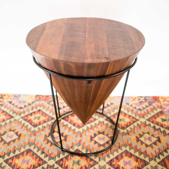 Photo of a upside down cone shaped table with metal legs 