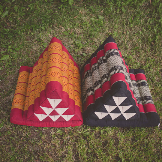 Photo of a folding yoga cushion in various positions, a black colour and a red/orange colour