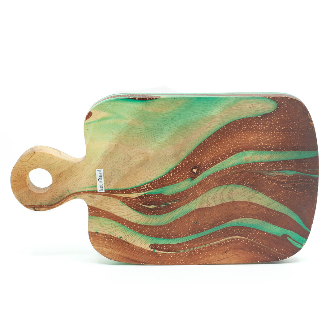 Photo of a mango wood cutting board in various colours featuring a dip dyed pattern