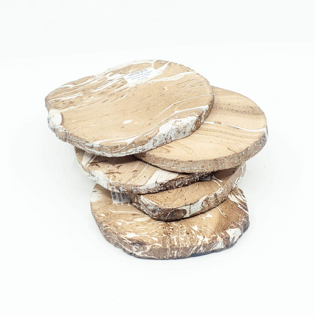 Photo of a mango wood coasters in various colours featuring a dip dyed pattern