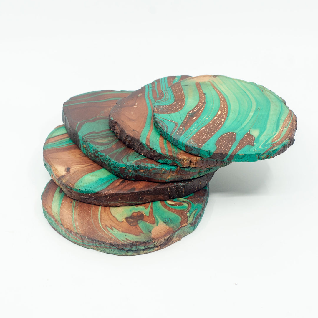 Photo of a mango wood coasters in various colours featuring a dip dyed pattern