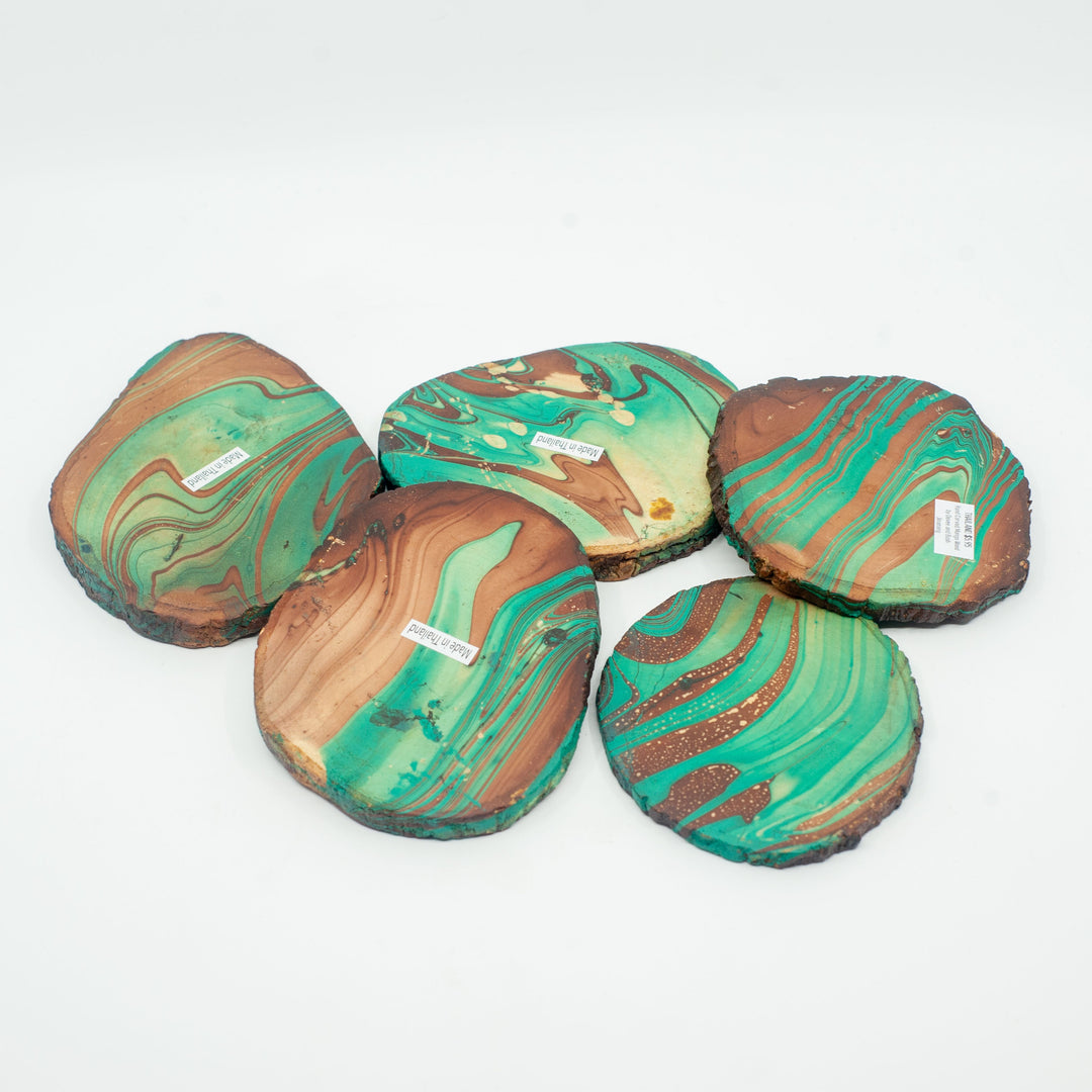 Photo of a mango wood coasters in various colours featuring a dip dyed pattern